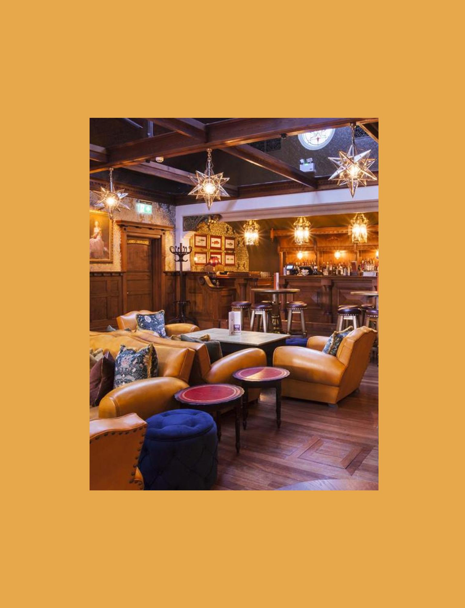 Opulent restaurant interior with plush seating, ornate lighting, and a classic wooden bar.