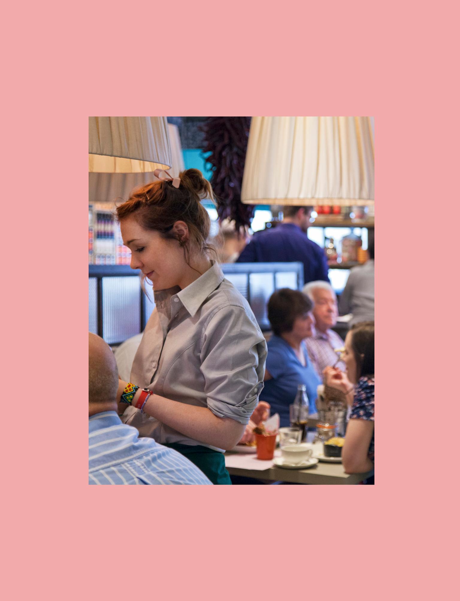Waitress taking order from customers in restaurant.