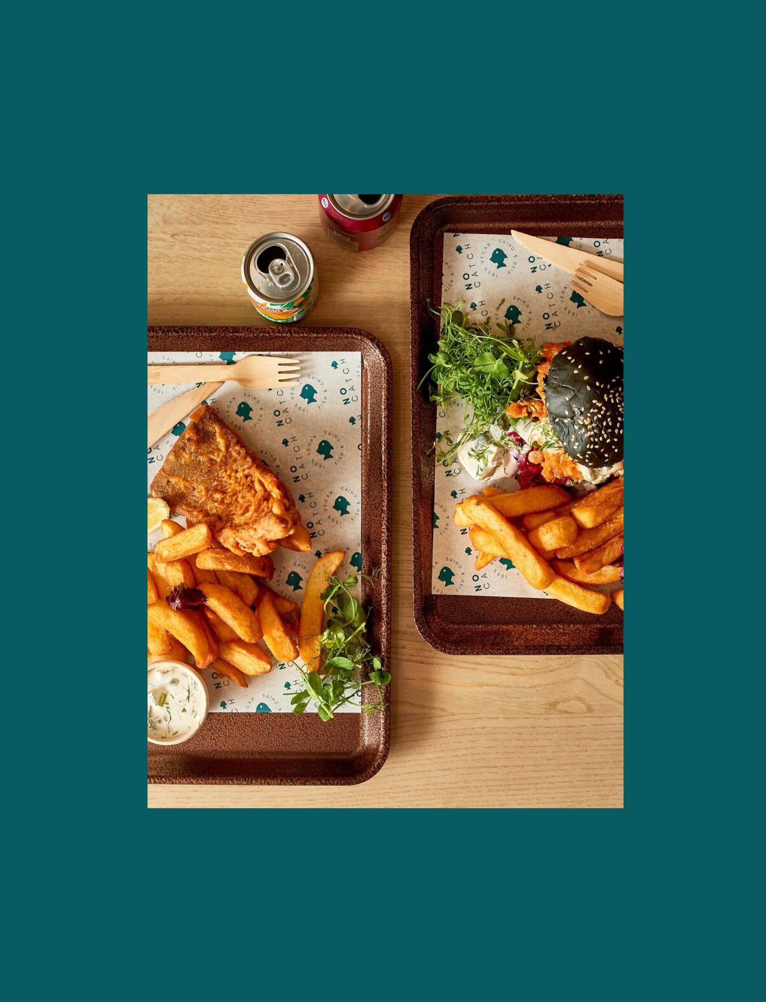 wooden trays with vegan fish and chips on them