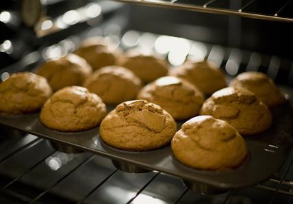 A tray of cupcakes baking in the oven