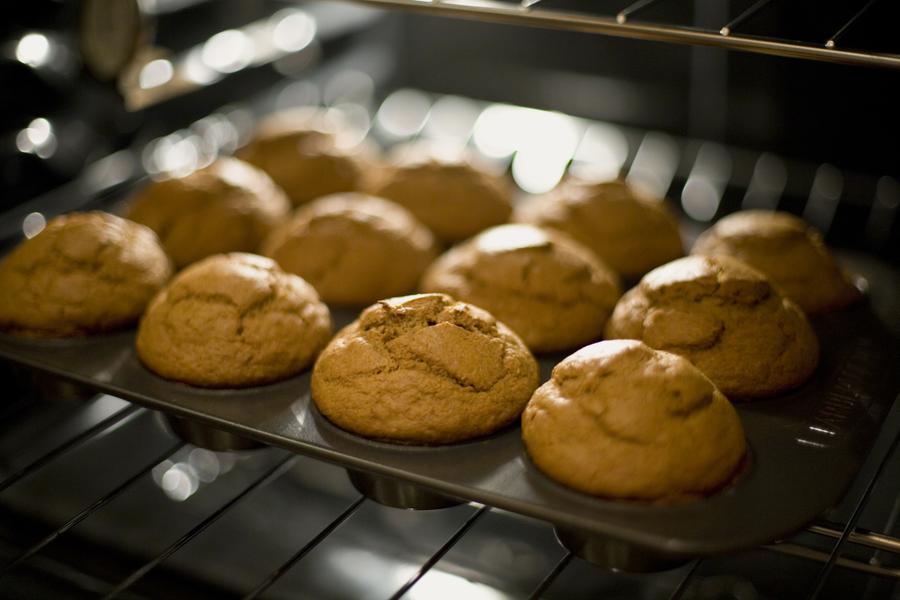 A tray of cupcakes baking in the oven