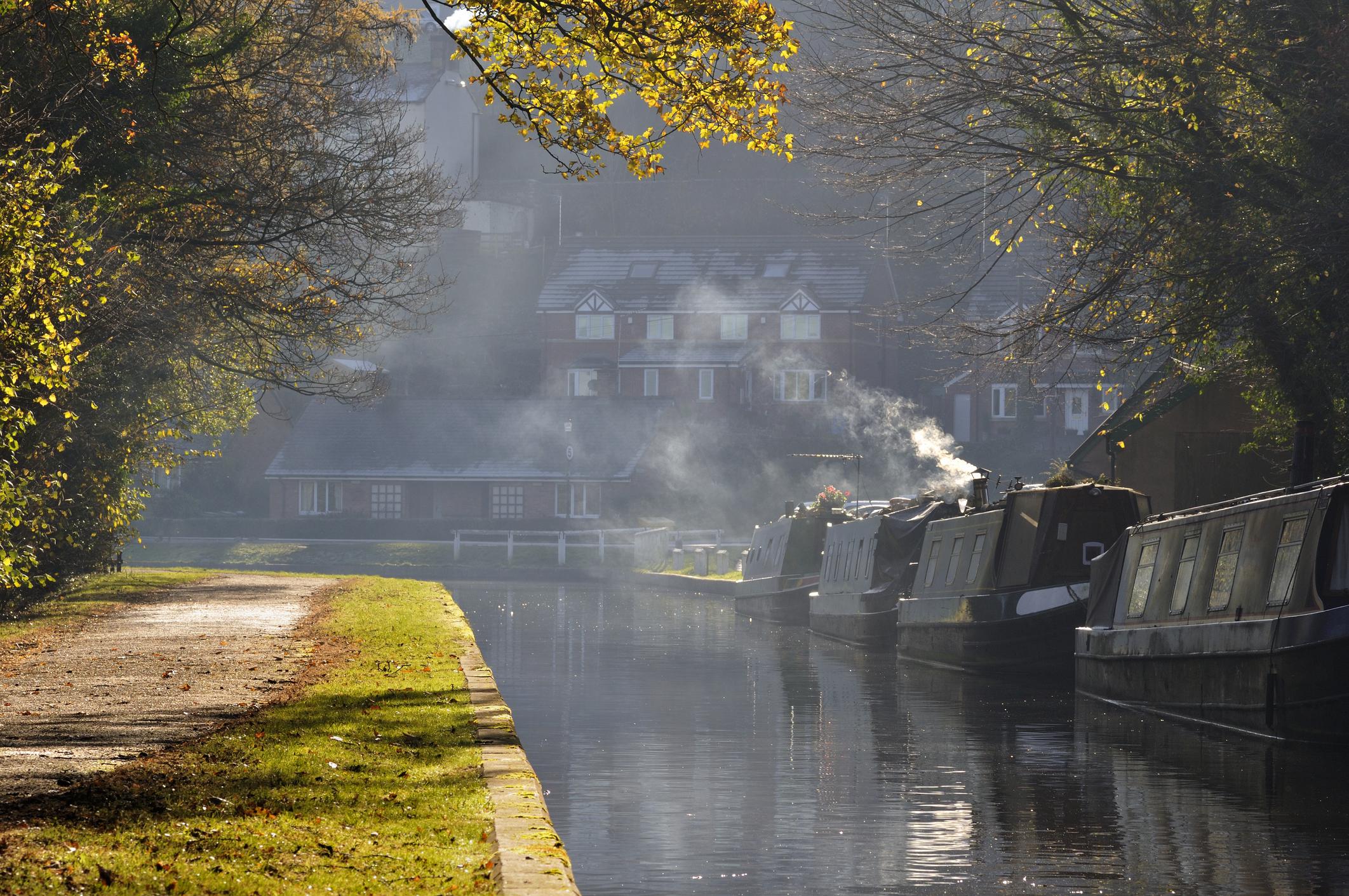 Image of Llangollen Canal on a cold day - there is smoke coming out of the chimney of a parked canal boat