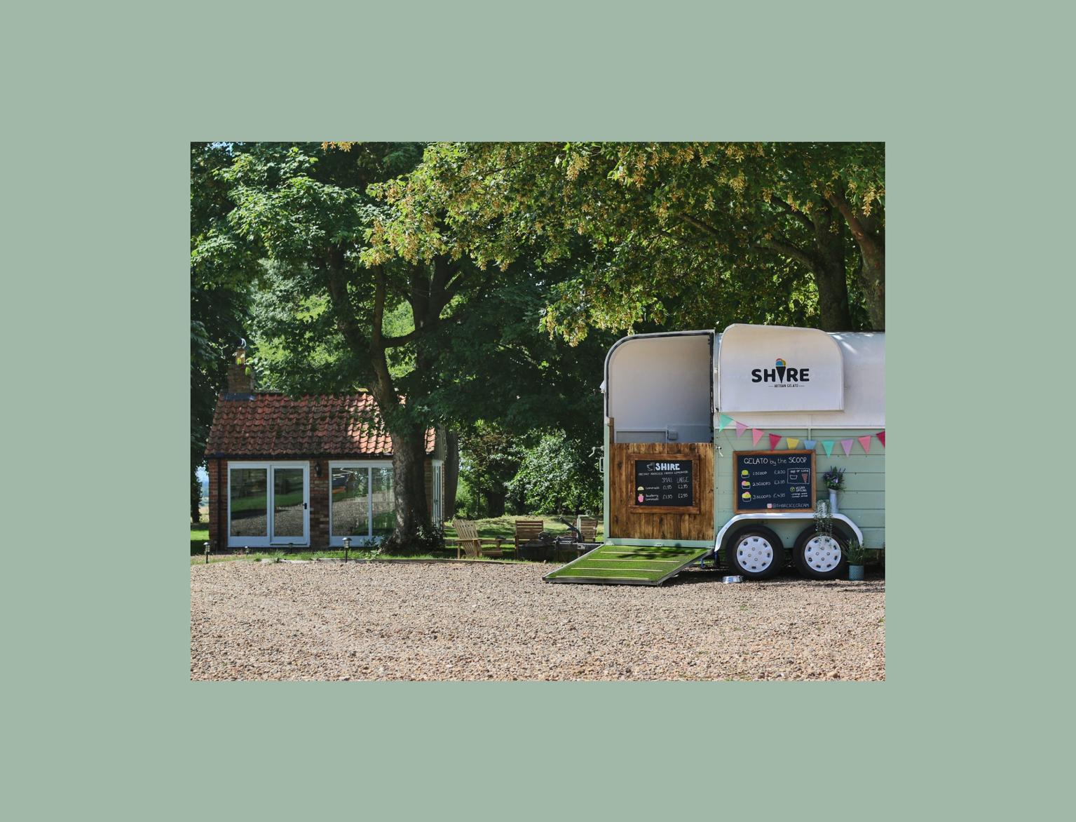 A picturesque county scene with a horse trailer converted into an ice-cream stall.
