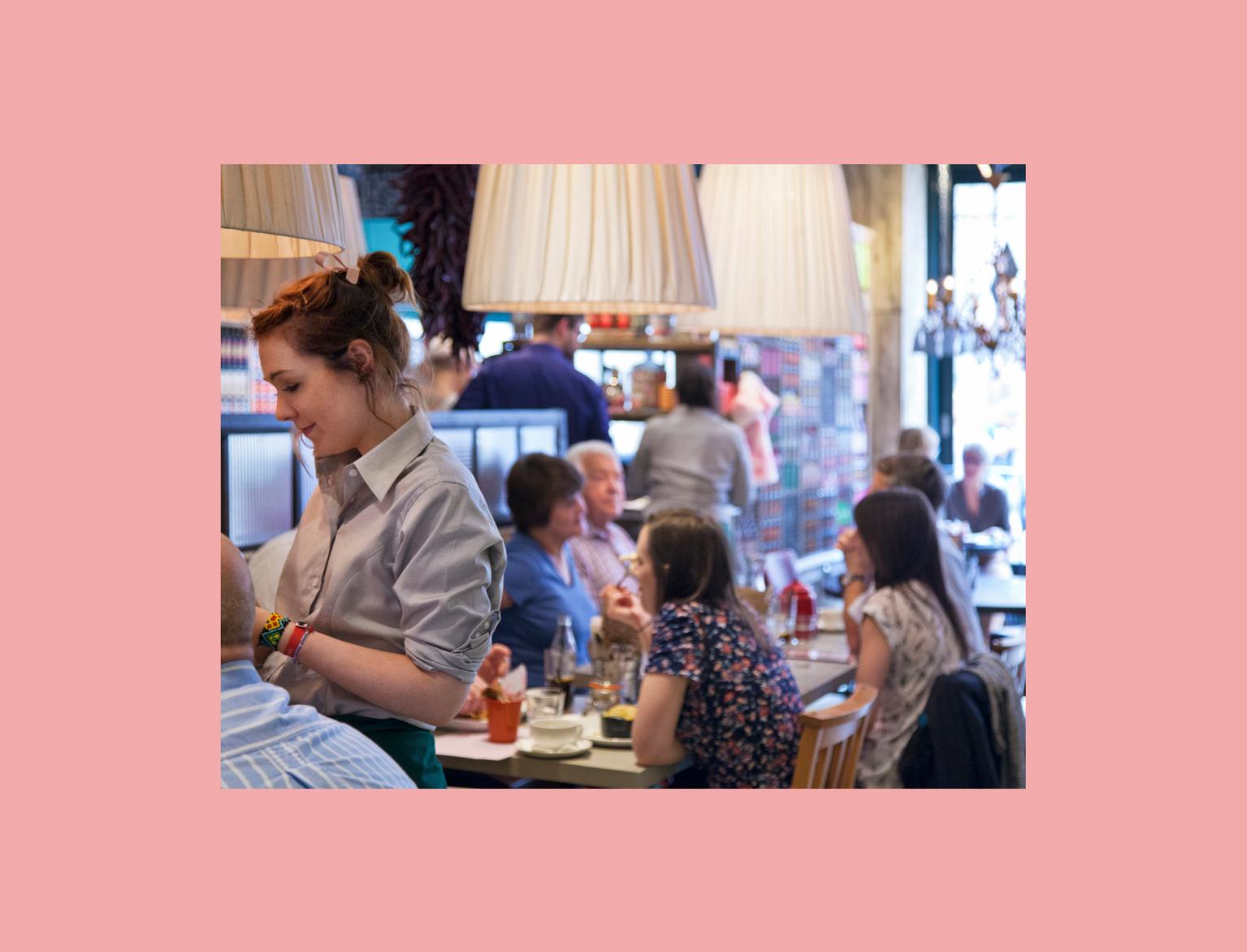 Waitress taking order from customers in restaurant.