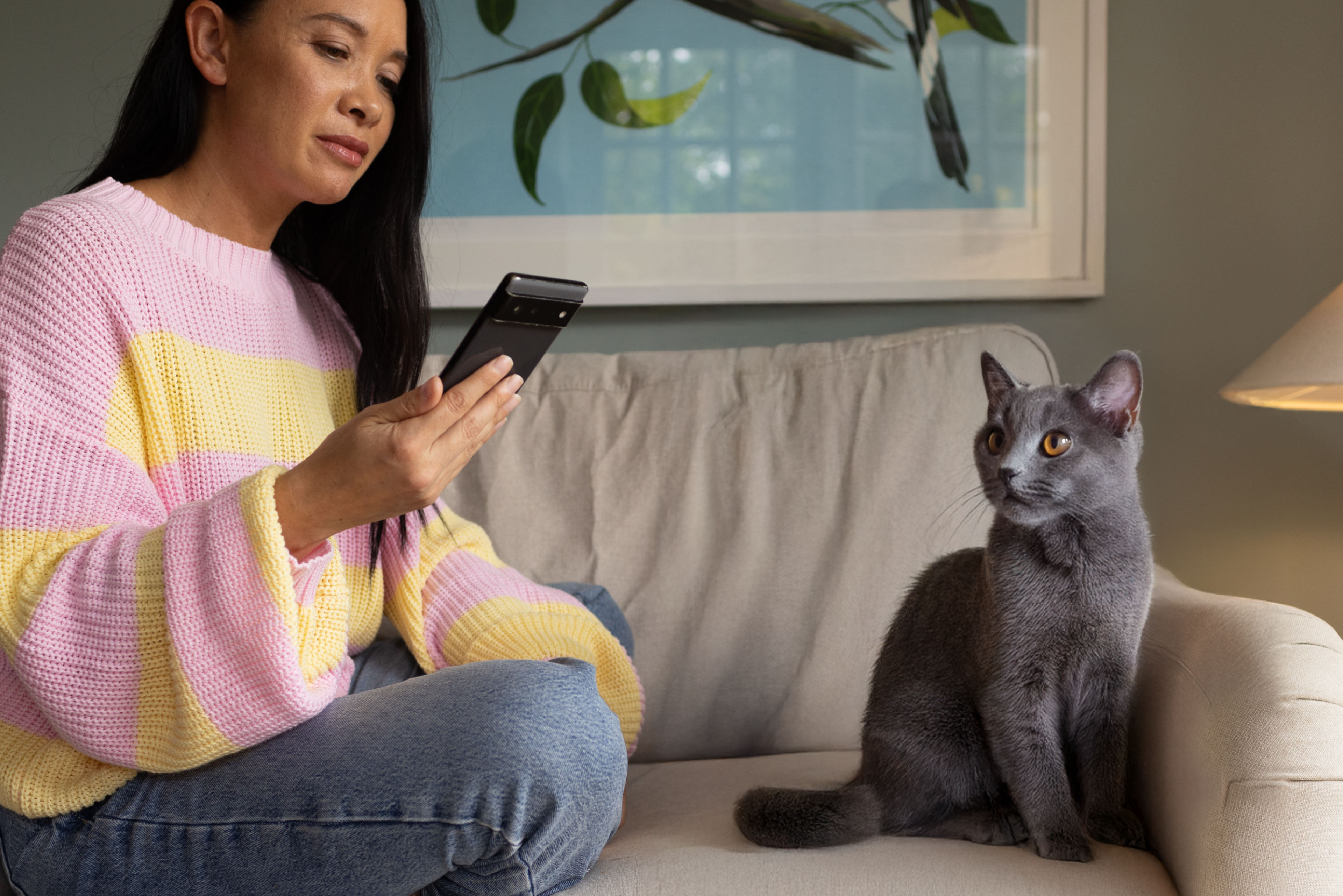Woman_on_phone_with_cat_next_to_her
