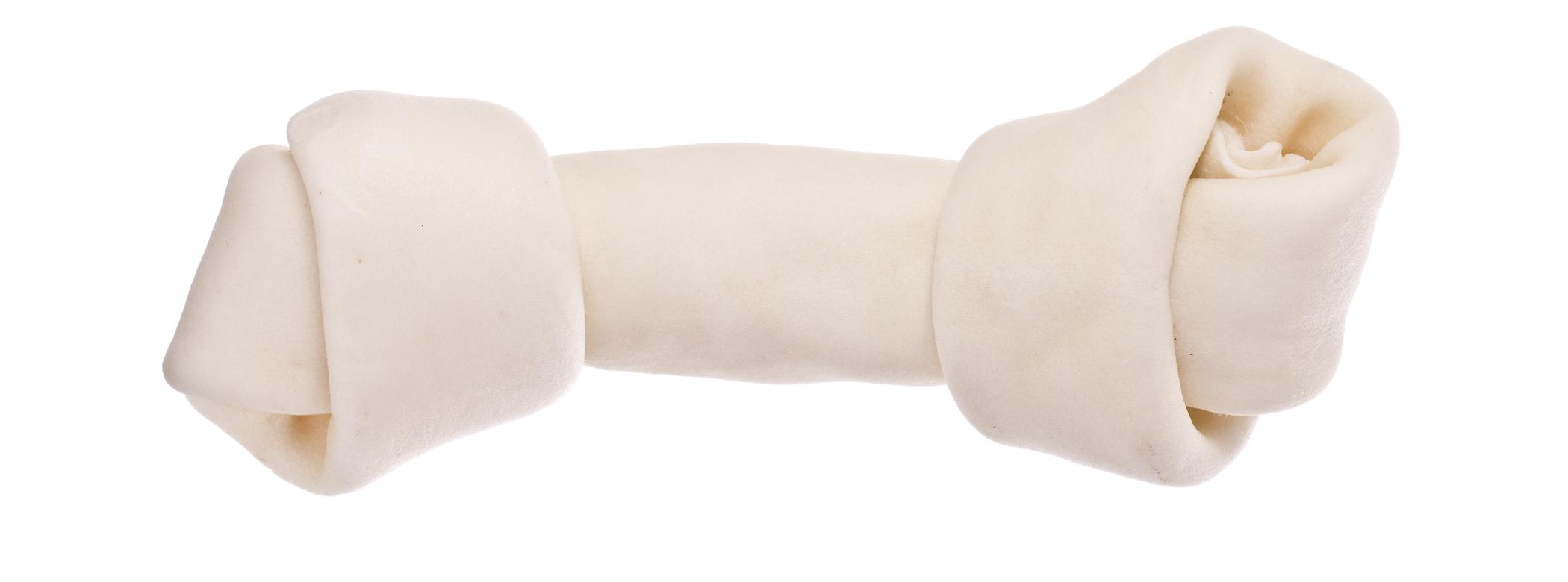 Close-up of a rawhide treat in the shape of a bone on a white background