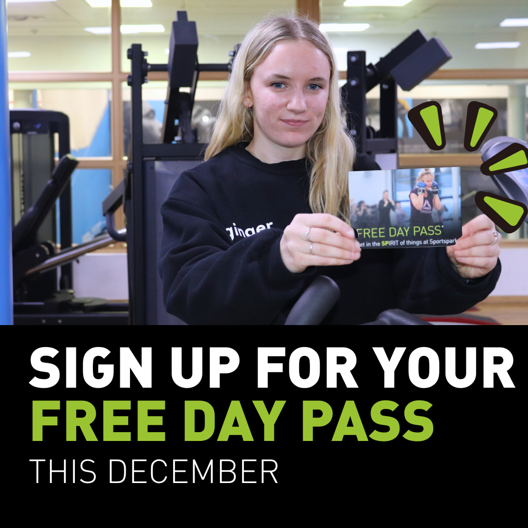 Young lady holding a free day pass card in a gym.