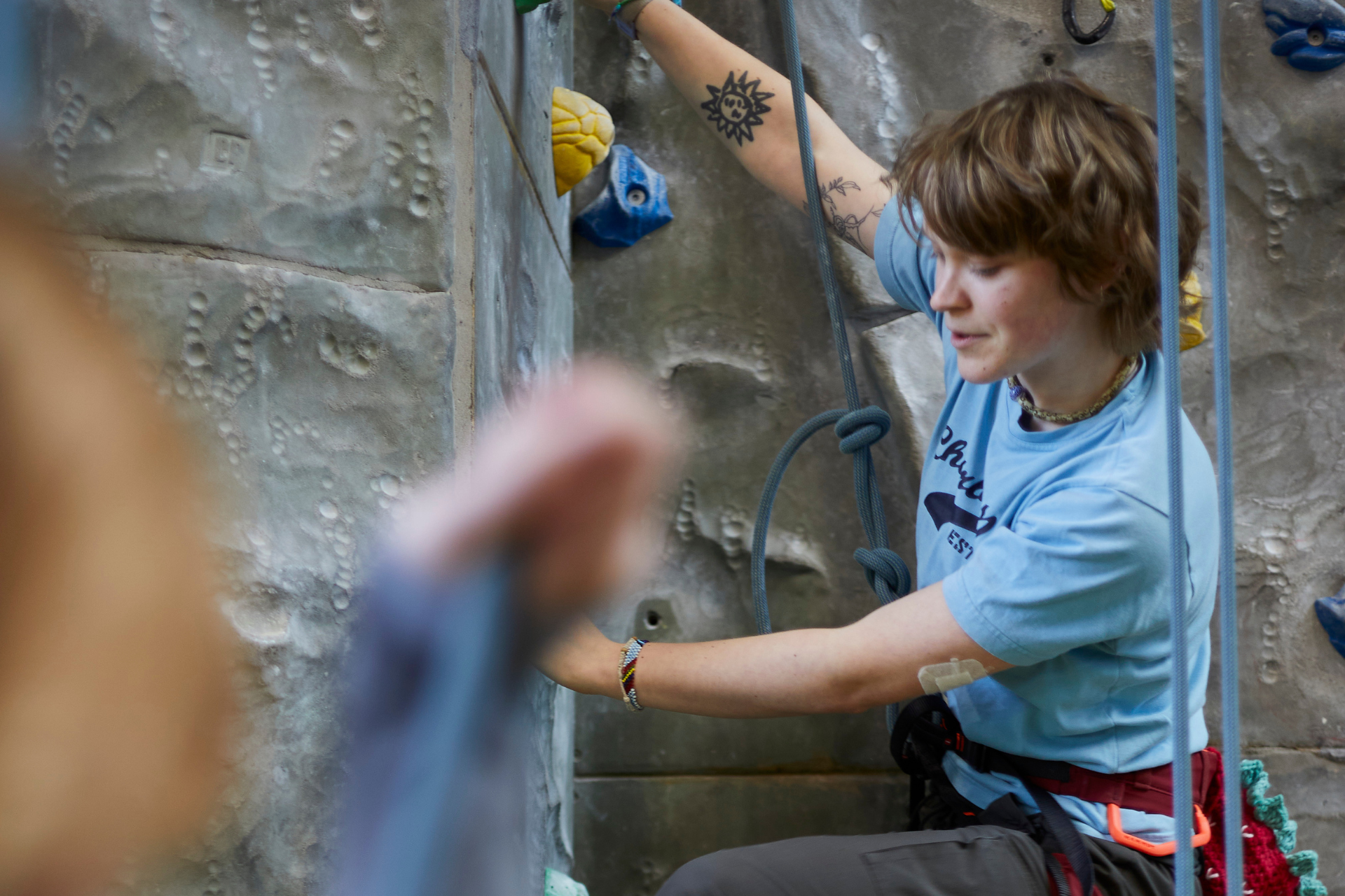 Woman on climbing wall.