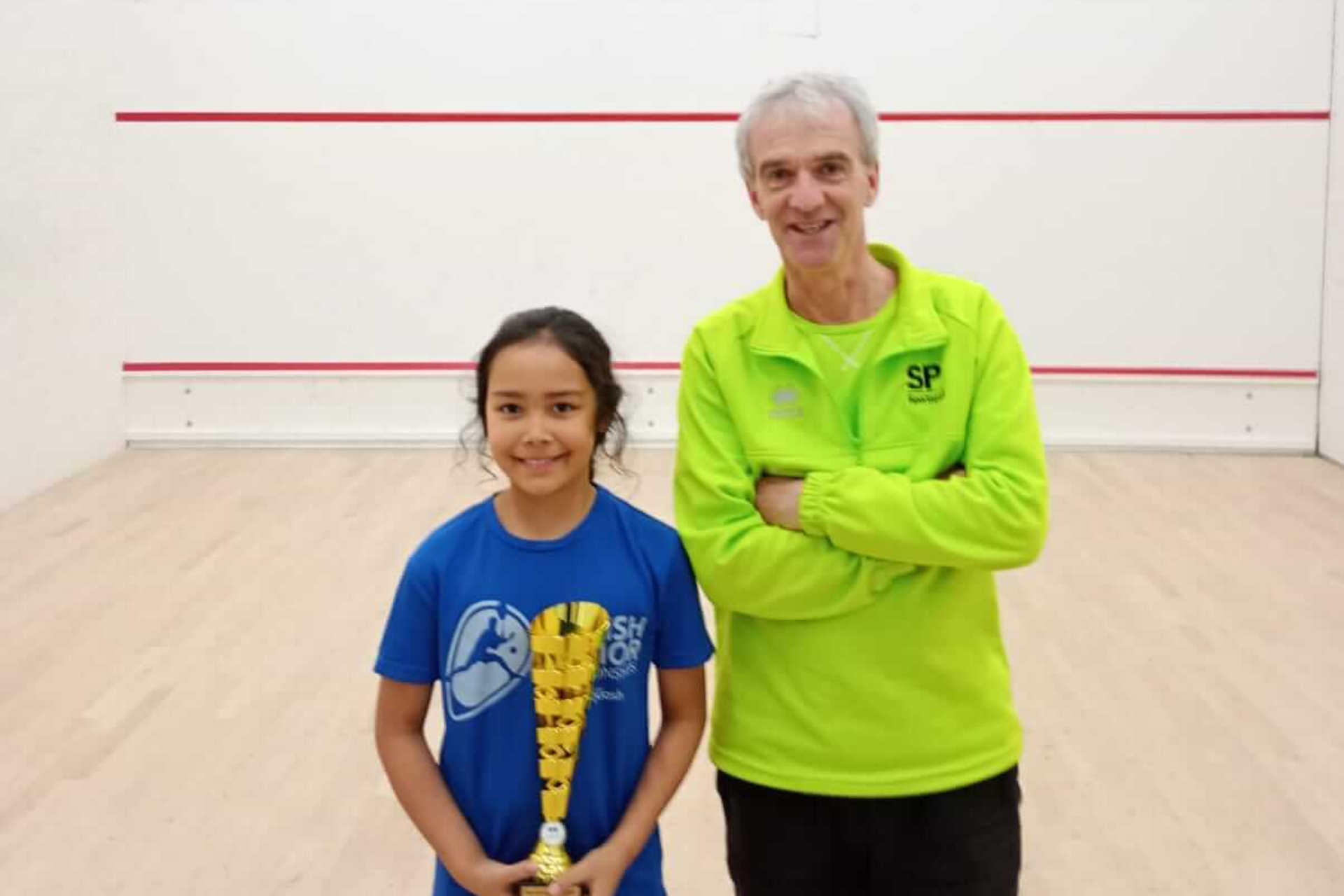 Instructor David and young student Ada in squash court