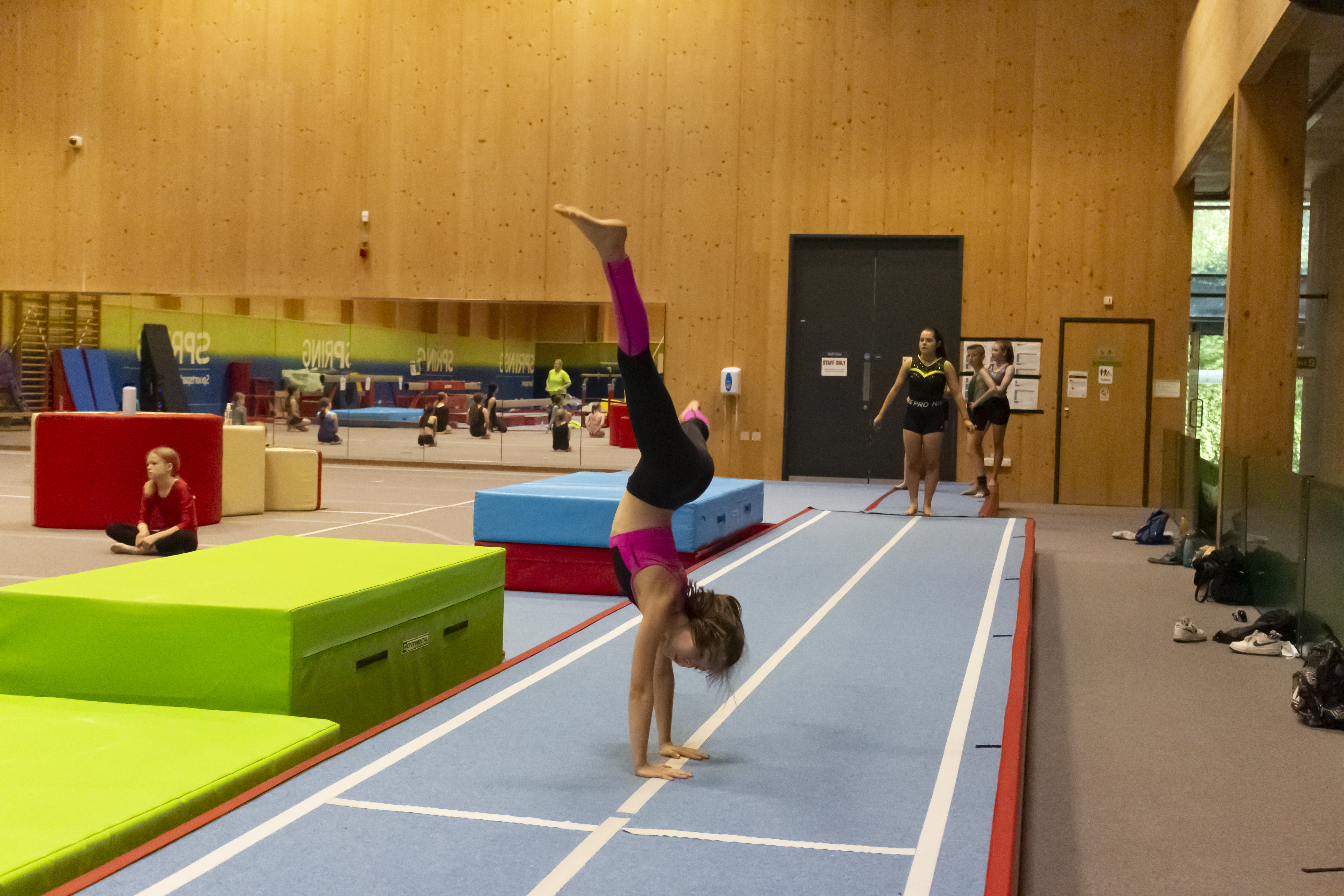 Girl doing cartwheel on tumble track.