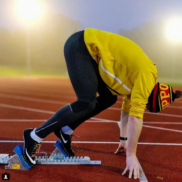 a runner on athletics track in sprint start position
