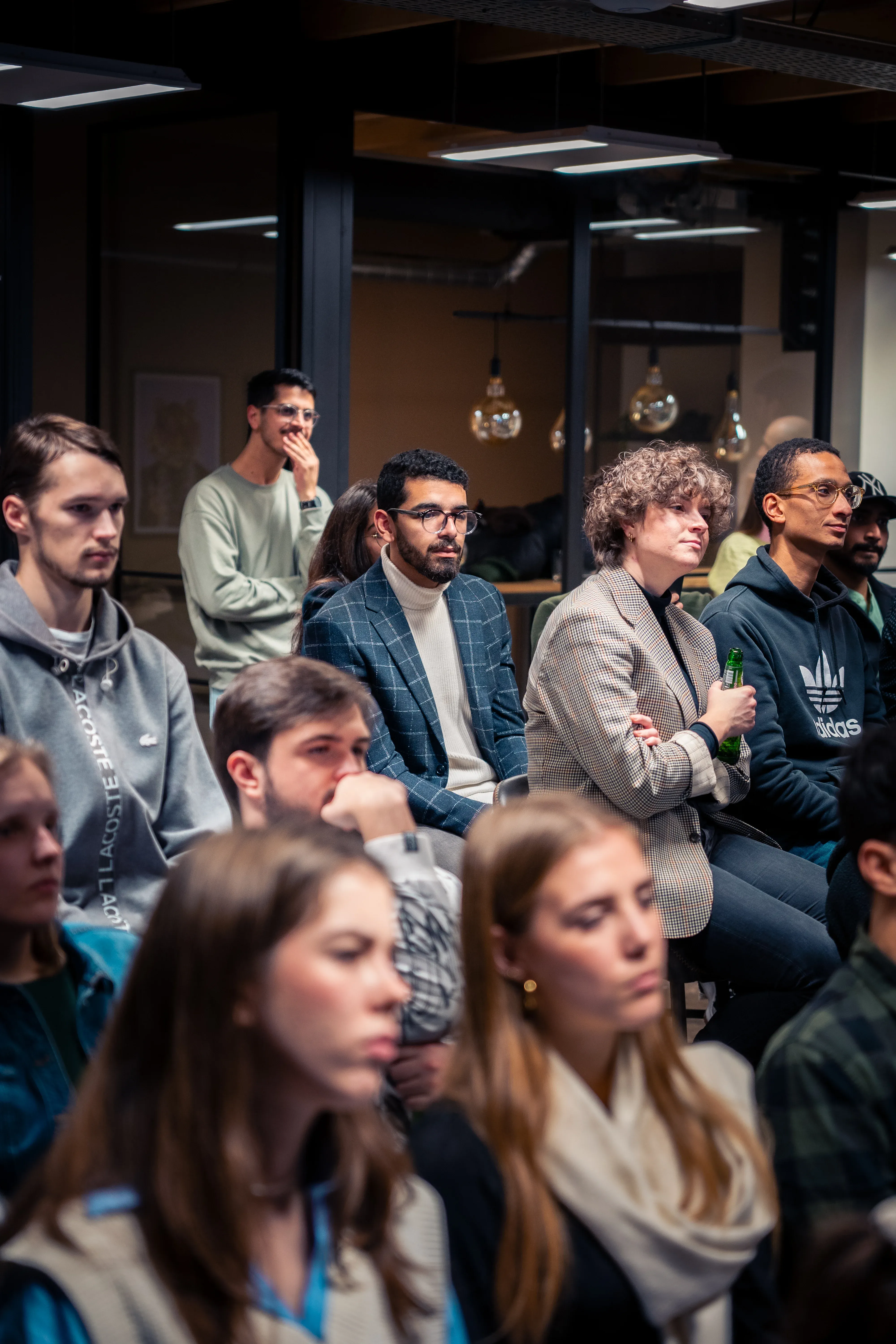 A group of people seated attentively at the data science meetup, with some standing in the background.