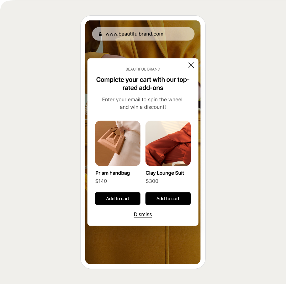 ai recommendation Pop-up on a website showing add-ons: a prism handbag for $140 and a clay lounge suit for $300, with "Add to cart" buttons.