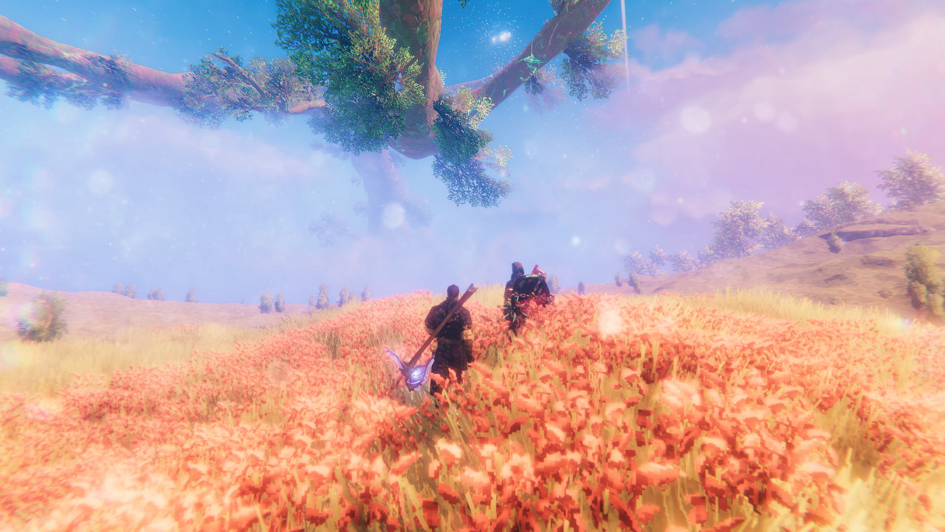 Official Valheim screenshot showing two players crossing a bright meadow beneath Yggdrasil