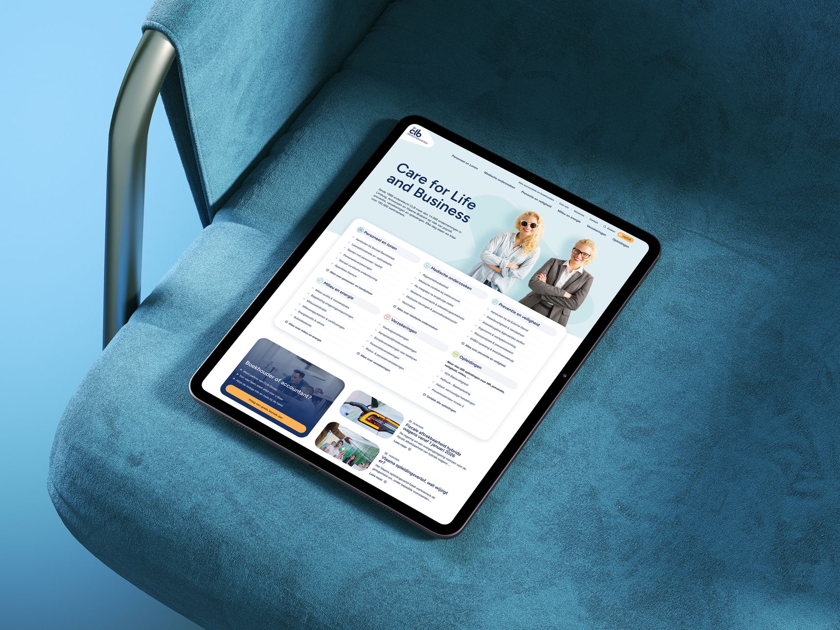 A tablet displays a website with a blue-themed design, showing business information and images of two professionals, resting on a blue chair.