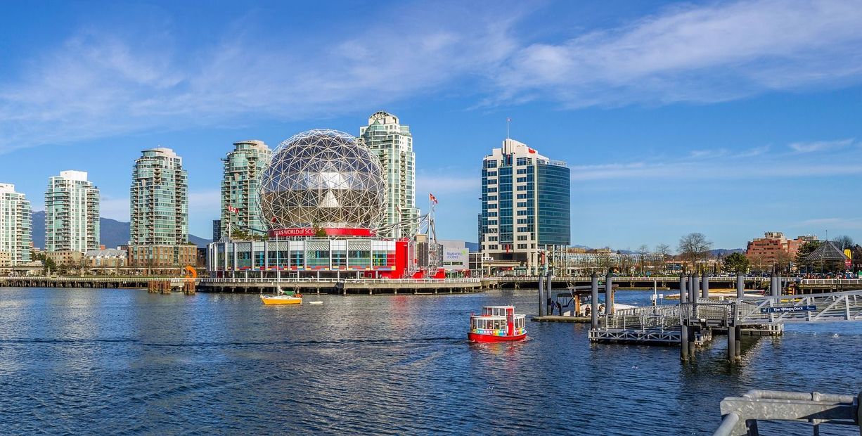 Science World geodesic dome and other buildings by the water in Vancouver