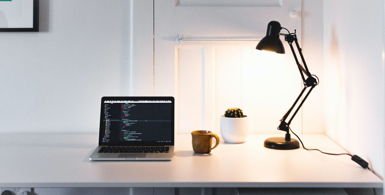 Laptop on a desk displaying rails deployment on Heroku