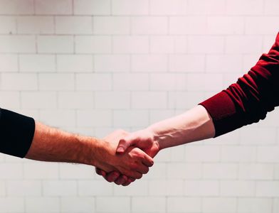 Handshake between a company representative and PEO