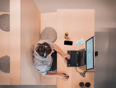 Man in headphones running startup payroll