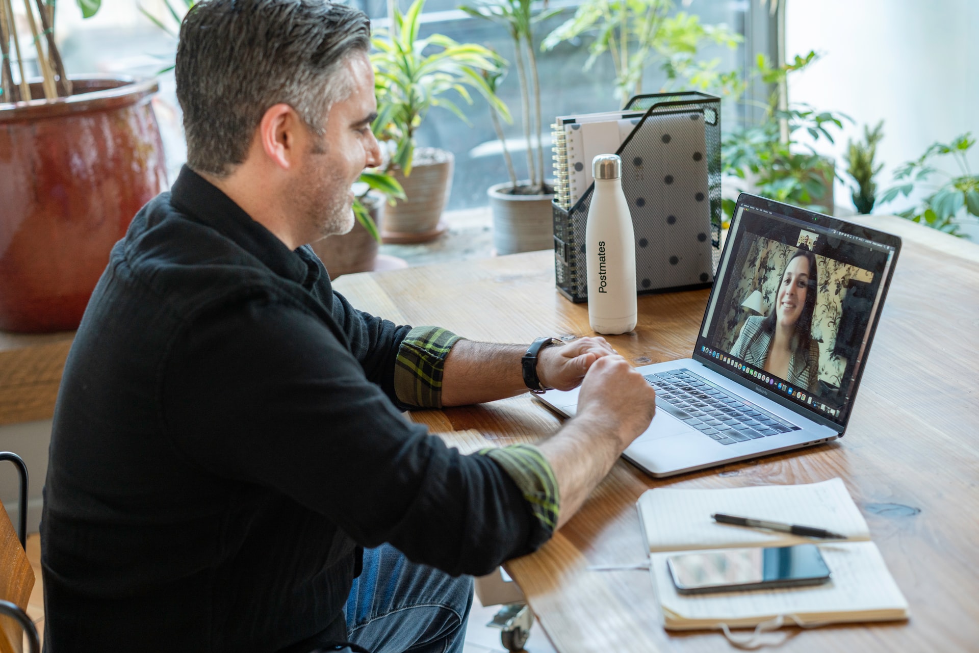 A man is having a video call with a woman