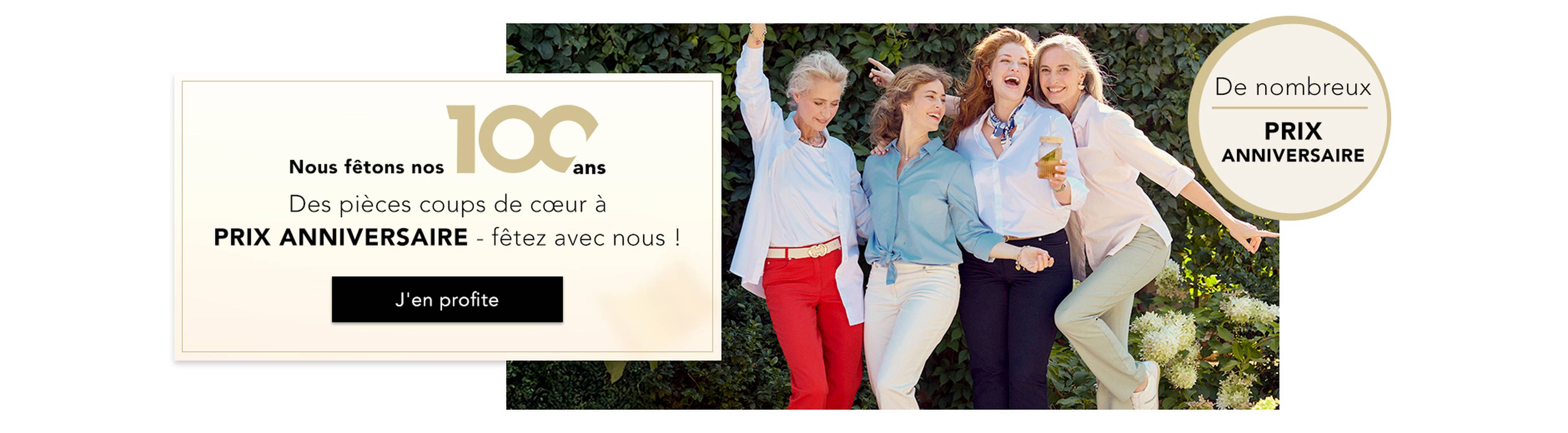  Un groupe de femmes fait la fête dans des tenues élégantes ; sur une banderole, on peut lire « 100 ans » et « PRIX FÊTIERS ».