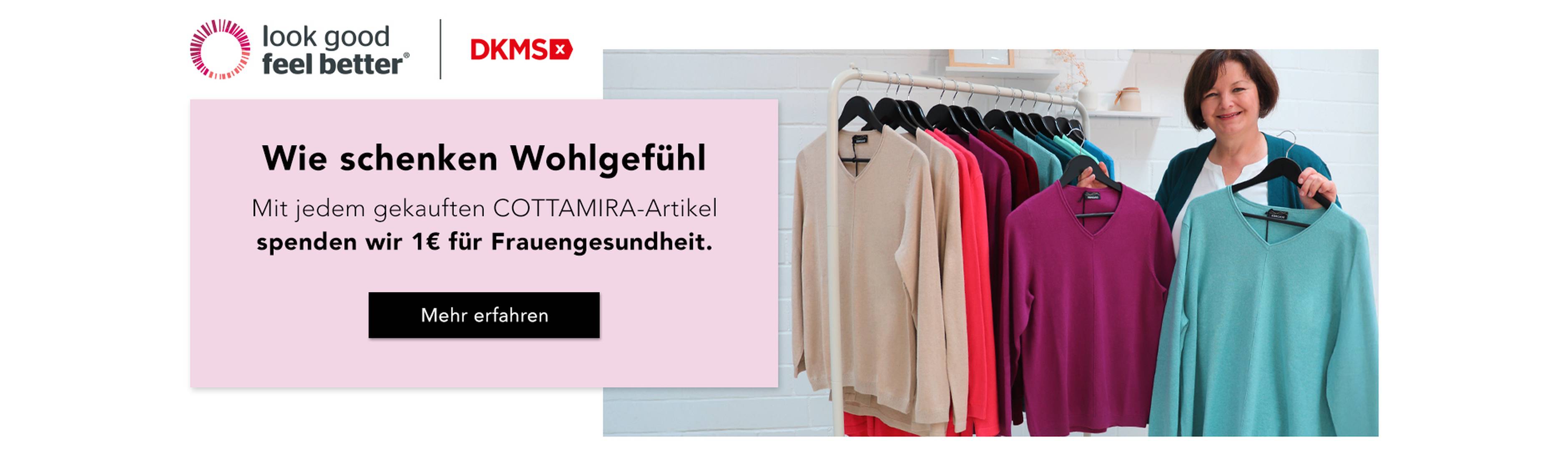 Eine Frau steht neben einem Kleiderständer mit bunten Pullovern und wirbt für eine Wohltätigkeitsinitiative für die Gesundheit von Frauen.