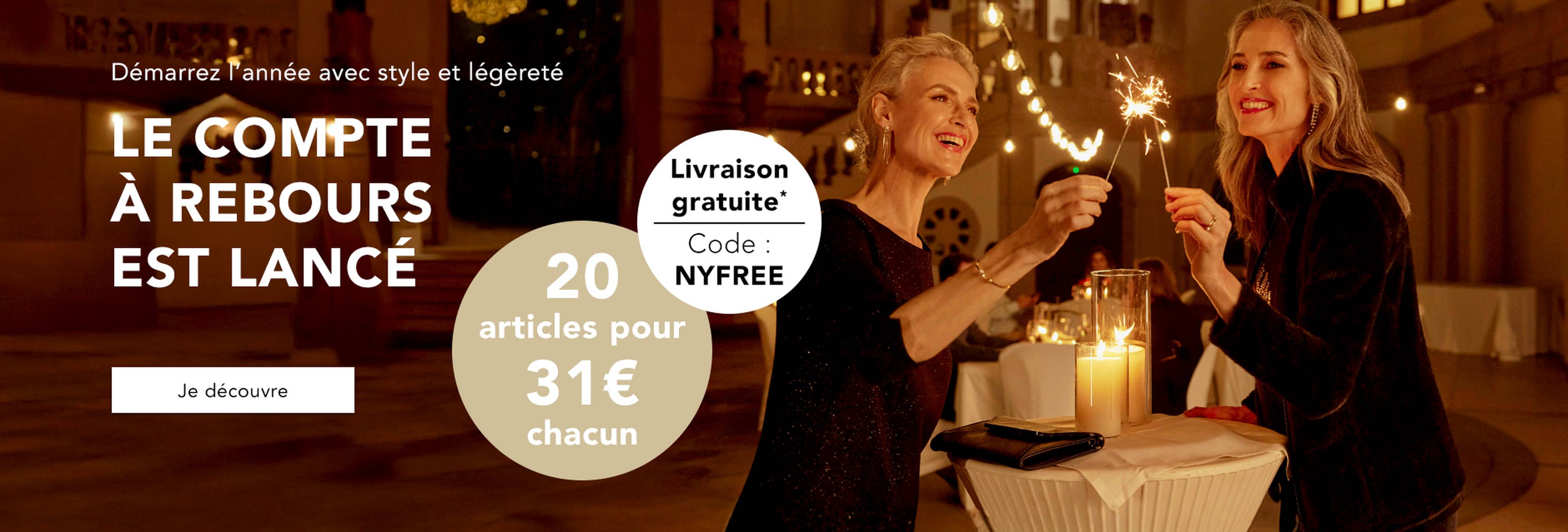 Deux femmes sont confortablement installées dans une ambiance de Noël – Découvrez la mode avec un bon d'achat de 25 €.