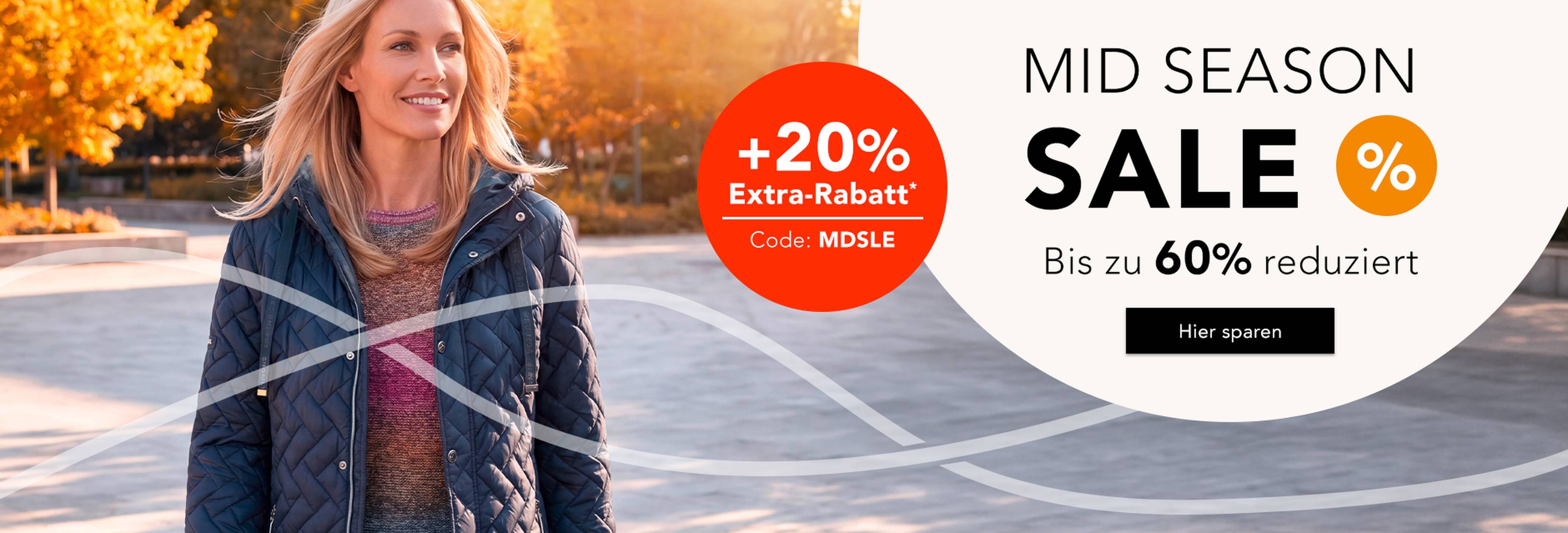 Frau in herbstlicher Umgebung trägt elegante Jacke. Mid Season Sale mit bis zu 60% Rabatt. Aktion mit +20% Extra-Rabatt. 
