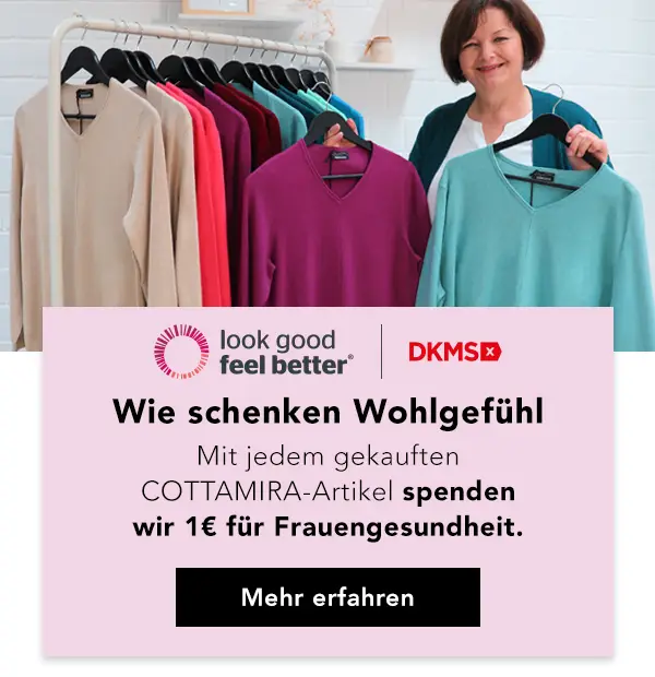 Eine Frau steht neben einem Kleiderständer mit bunten Pullovern und wirbt für eine Wohltätigkeitsinitiative für die Gesundheit von Frauen.
