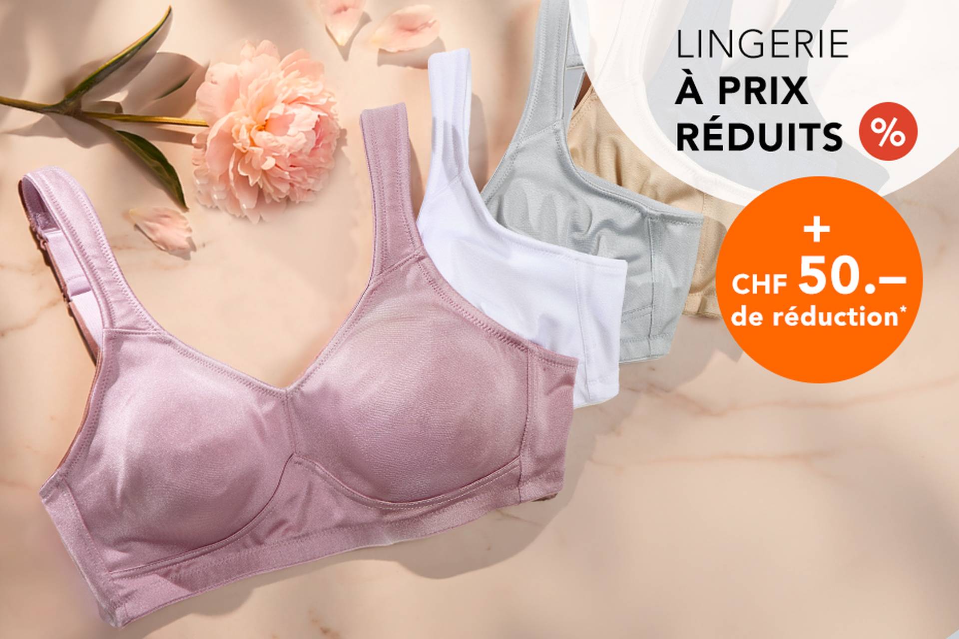  Trois soutiens-gorge aux couleurs douces posés sur une surface, accompagnés d'une fleur. Le texte promotionnel met en avant des réductions allant jusqu'à 70 % et une remise supplémentaire de 20 %.