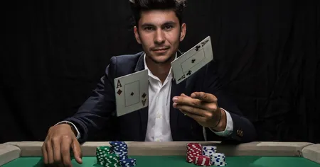 Man Throwing Two Aces into the Air with stacks of chips on a green table