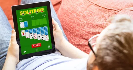 Man playing solitaire on a tablet