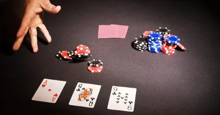 Three open cards, 2 closed hole cards, a hand throwing chips