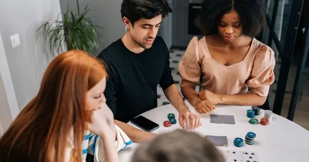 Four recreational players playing poker at a round table