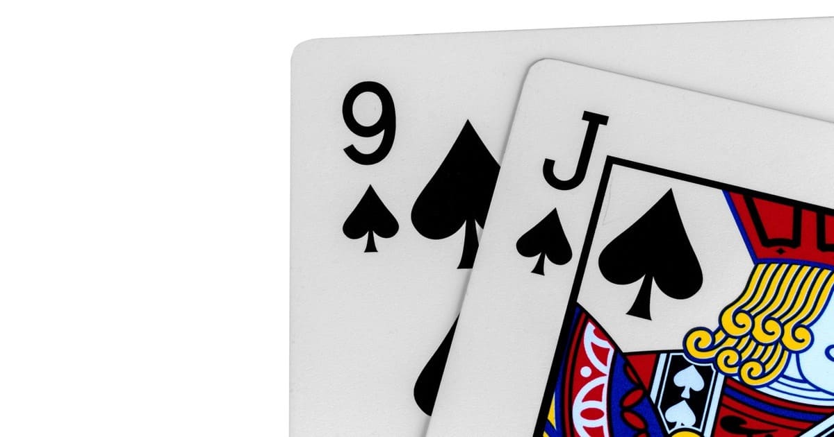 Close-up of playing cards showing the 9 of spades and Jack of spades, partially overlapping, on a white background.