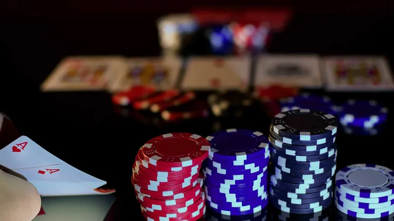 Pocket aces, stacks of chips, community cards