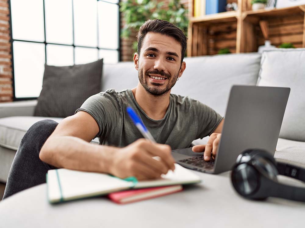 College student studying on laptop in apartment protected by affordable renters insurance