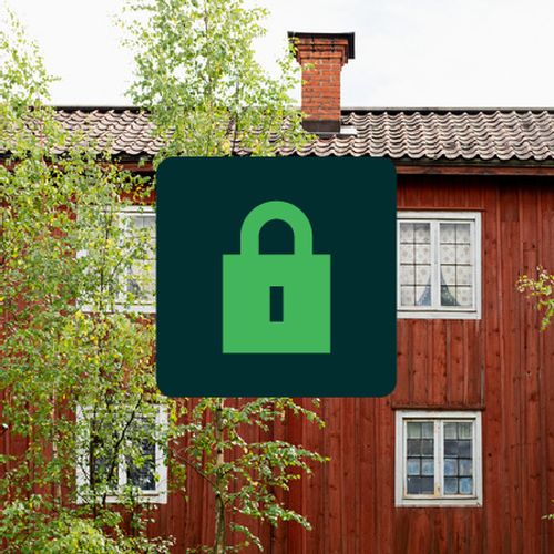 Rött hus med vita spröjs och nyckelsymbol.