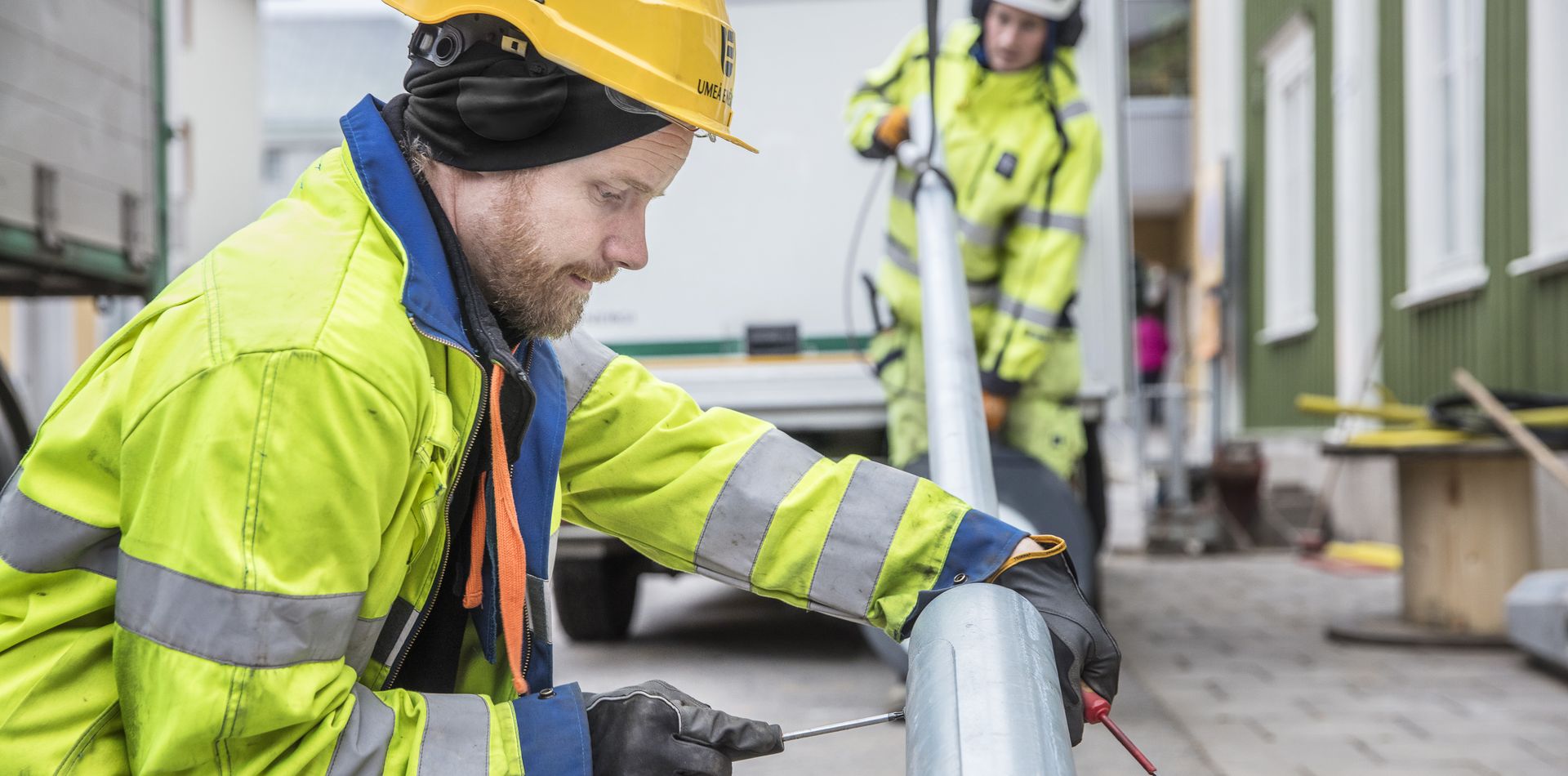 Anställd som skruvar i lyktstolpe