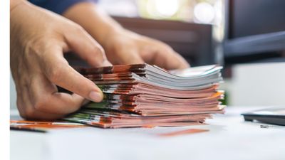 Person holding pamphlets for marketing