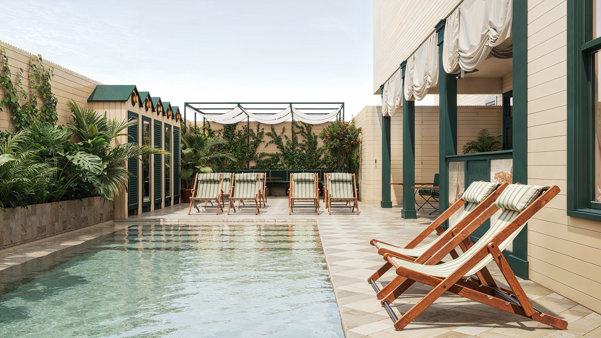 Outdoor pool area with striped deck chairs, lush plants, and elegant cabanas. Beige and green color scheme creates a serene, inviting atmosphere.