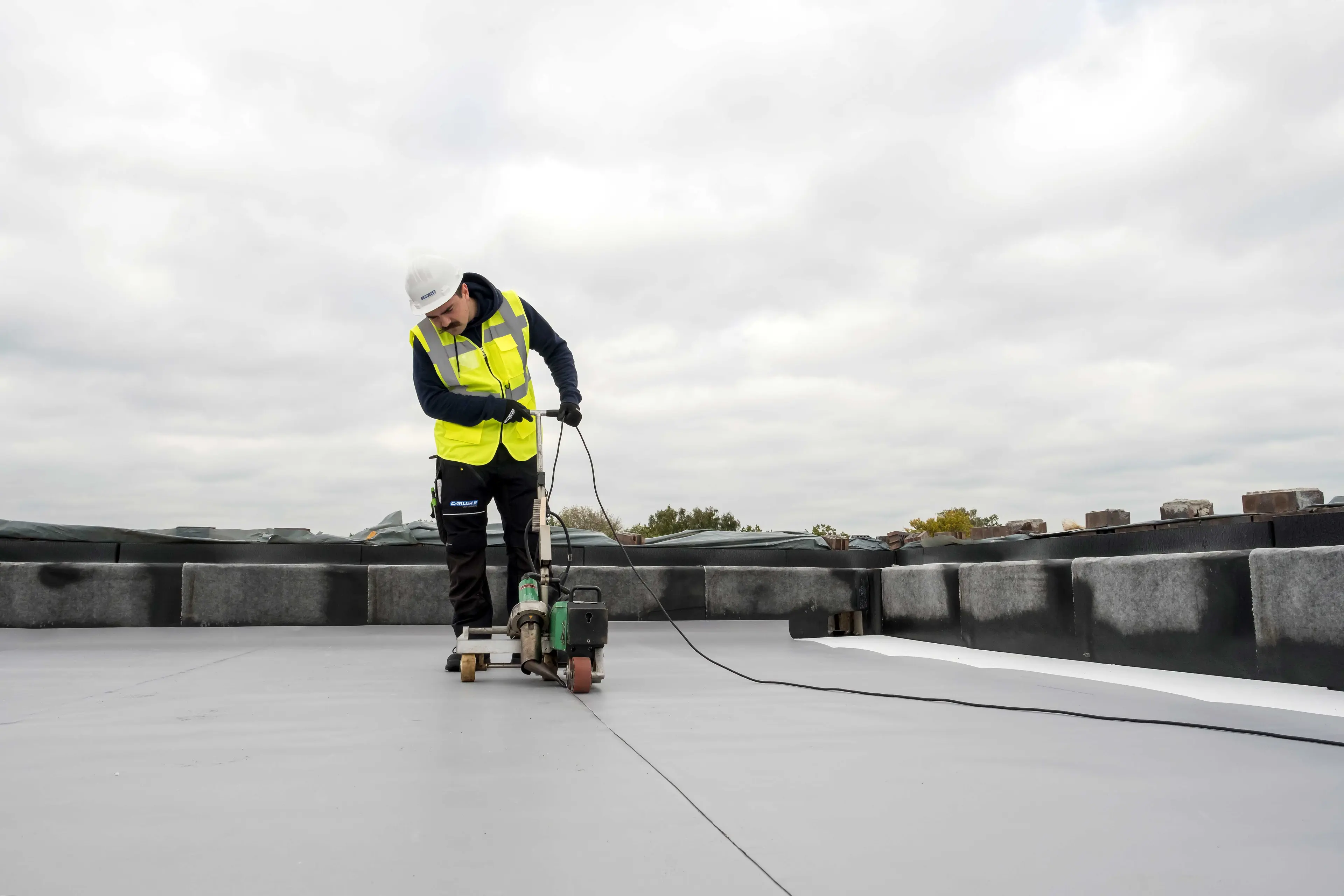 Roofer adding a tpo membrane to a roof