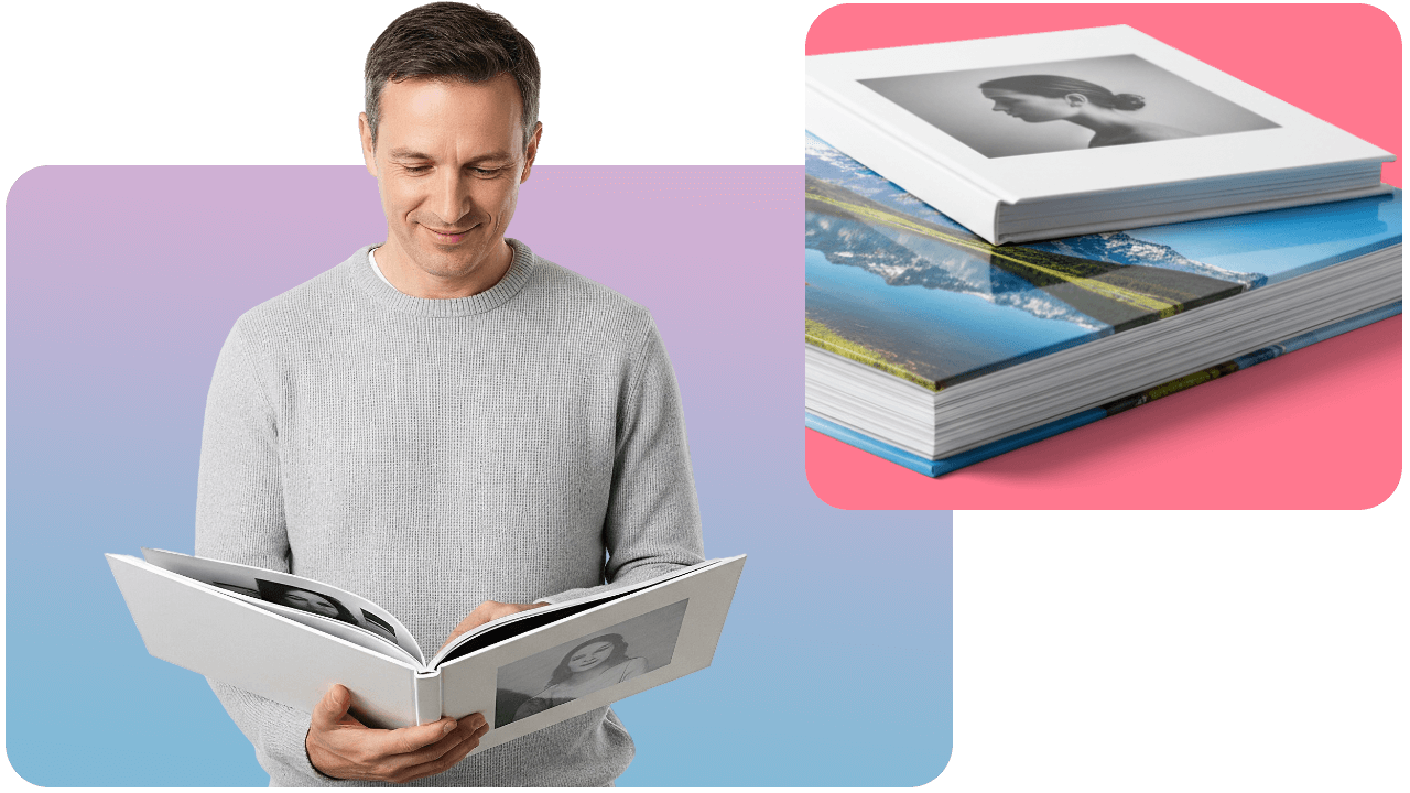 Man reading a photo book with a woman's picture on the cover; nearby, a stack of similar books with scenic covers on a pink surface.