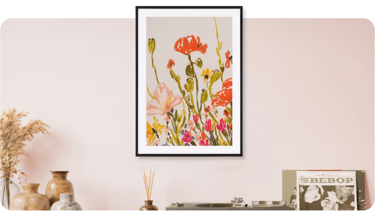 Framed floral painting on a light pink wall above a shelf with vases, dried flowers, and a record player with vinyl records.
