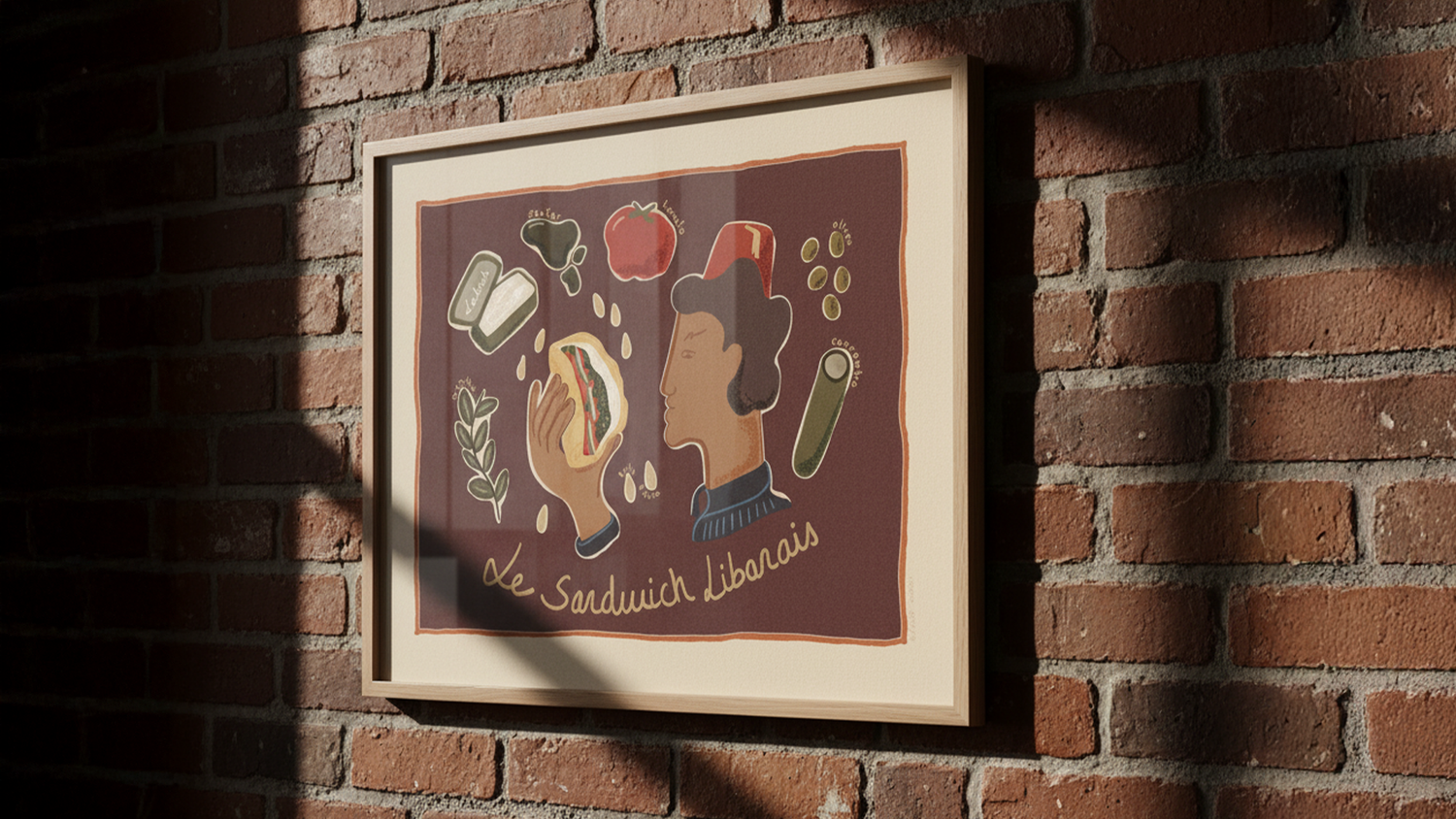 Framed artwork on a brick wall depicting a person eating a sandwich, surrounded by ingredients and the text "Le Sandwich Libanais."