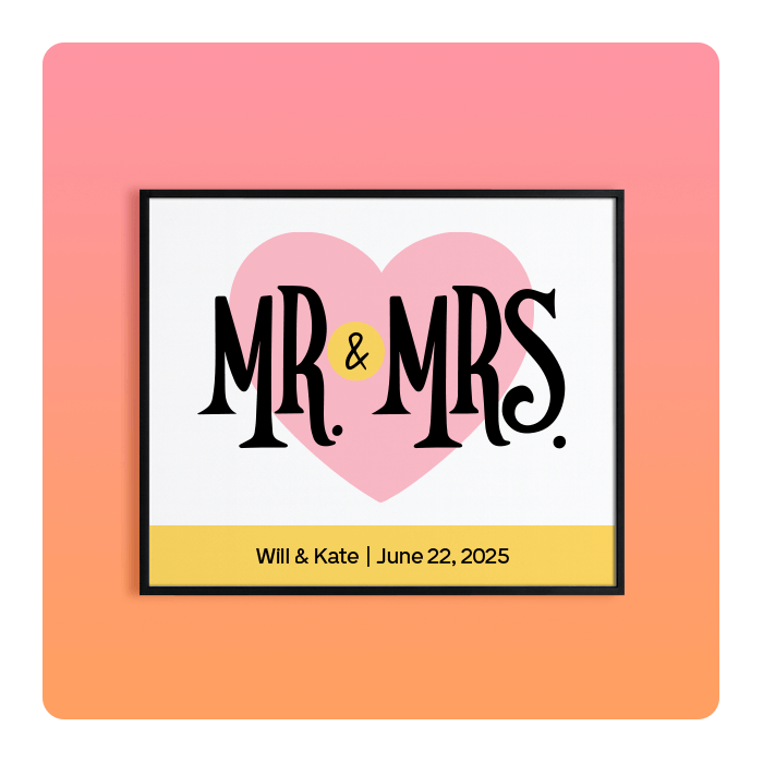 Framed print reading 'MR. & MRS.' in black over a pink heart with a yellow ampersand and gold strip reading 'Will & Kate | June 22, 2025'.
