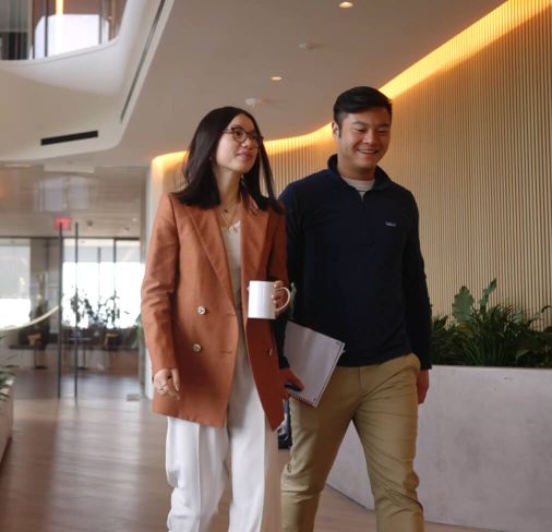 Man and woman walking in Third Point office hallway
