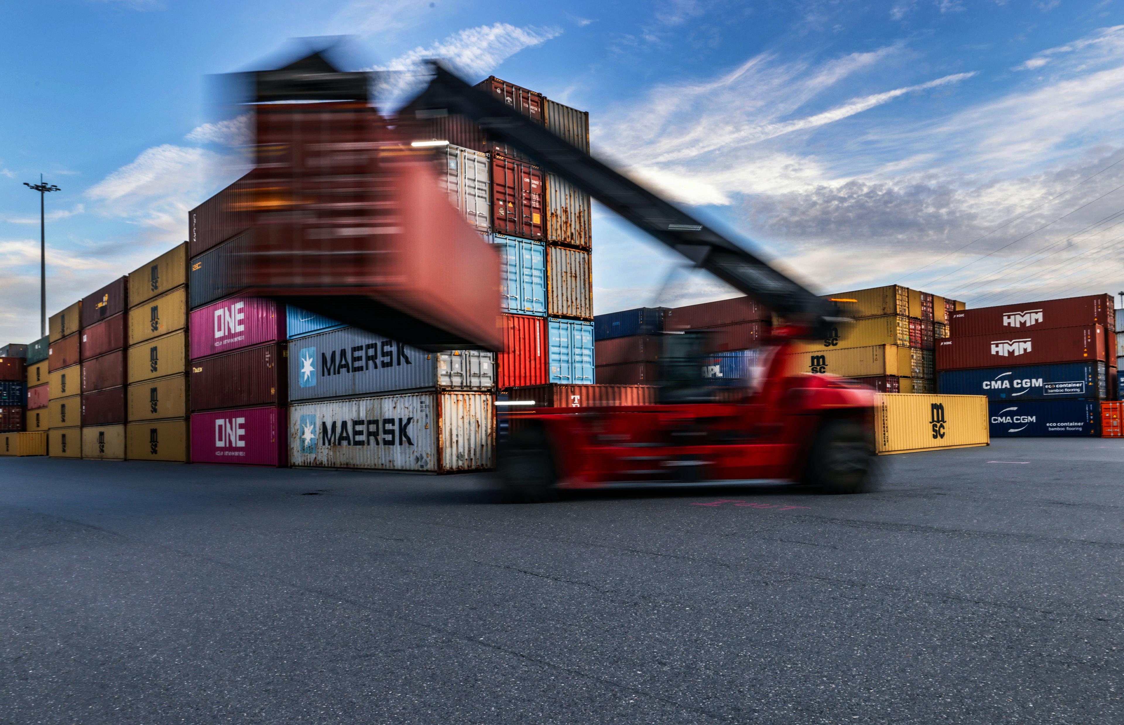 Container werden im Duisburger Hafen auf Binnenschiffe verladen.