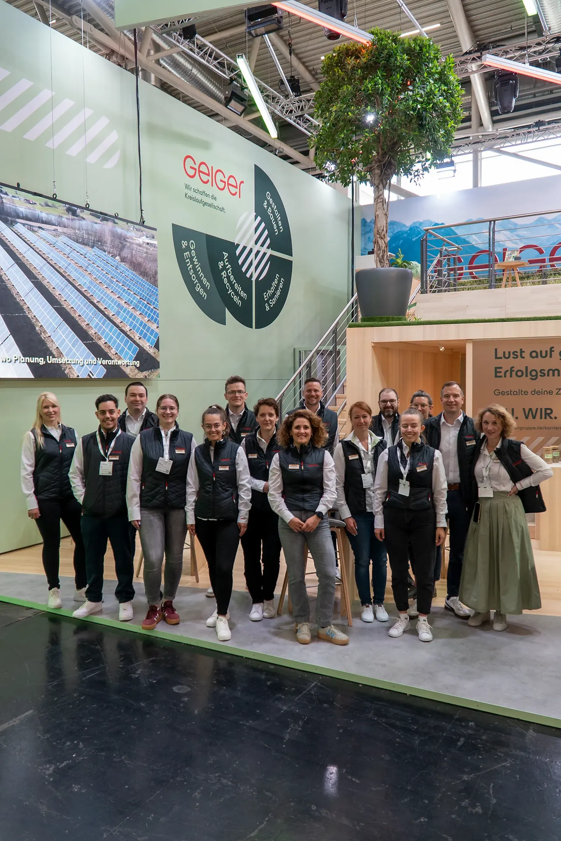 Eine Gruppe von Mitarbeitenden der Geiger Gruppe vor dem Messestand auf der IFAT in München.