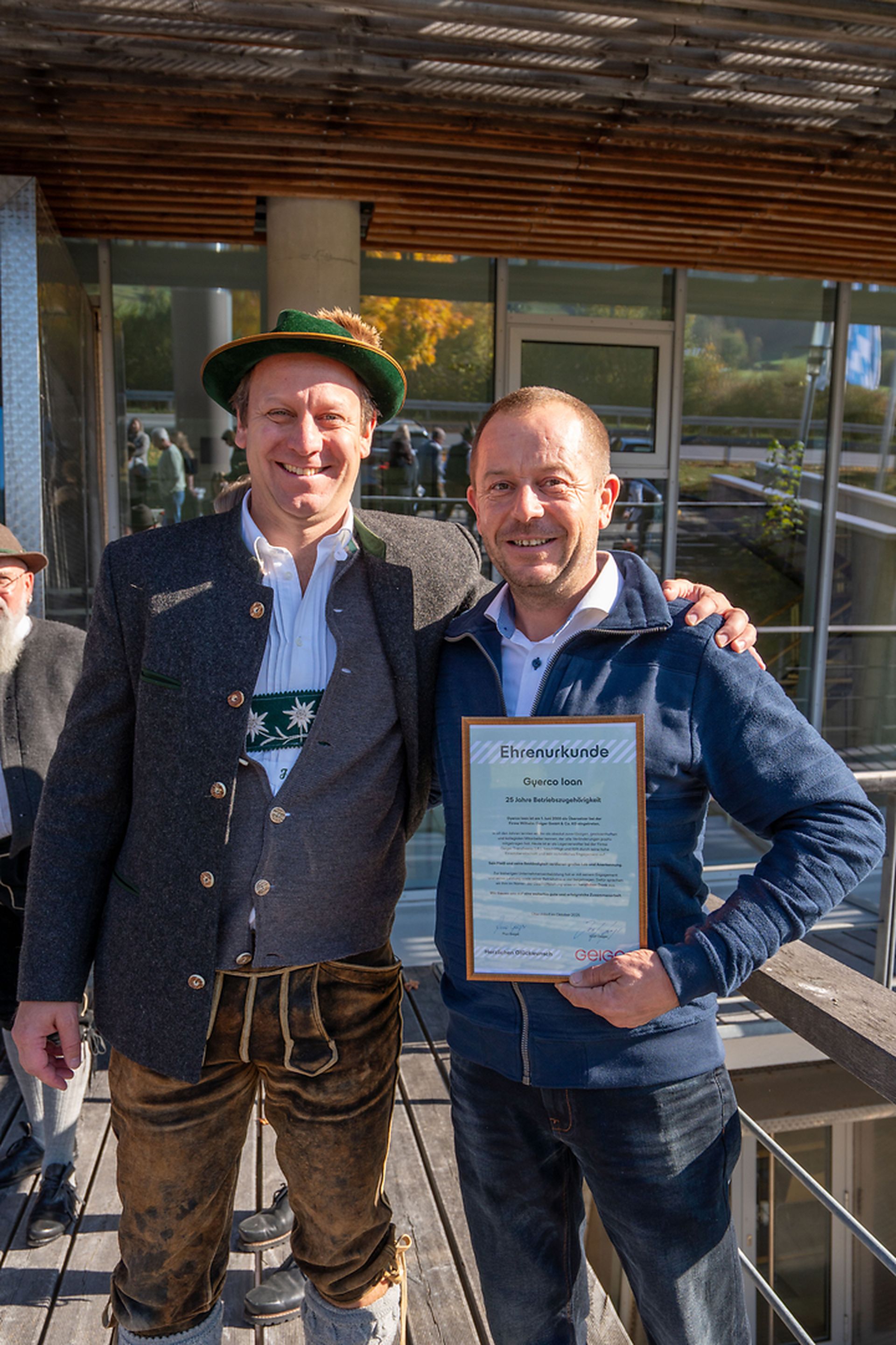 Josef Geiger überreicht einem rumänischen Kollegen eine Ehrenurkunde für 25 Jahre Betriebszugehörigkeit in Rumänien.